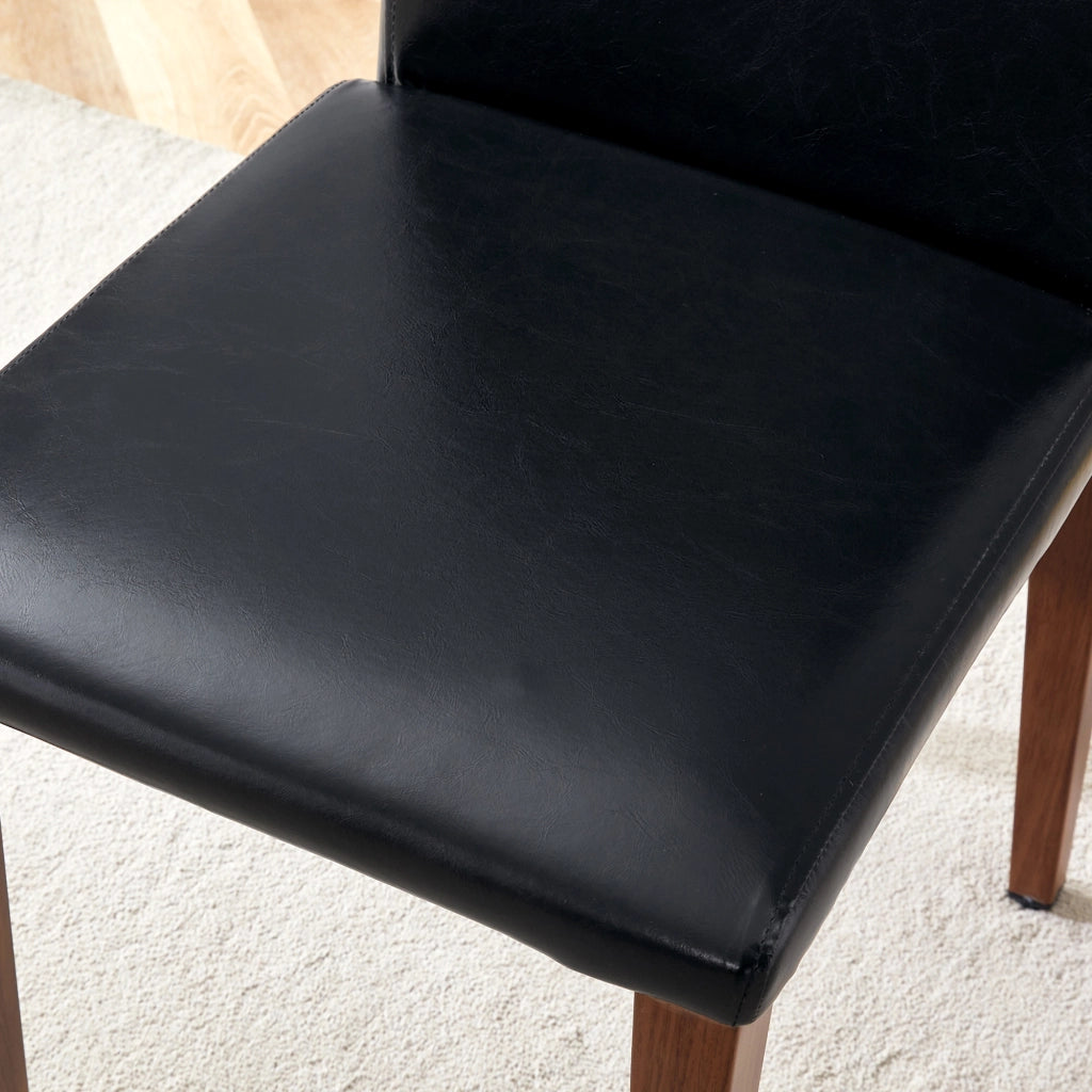 Set 4 sedie da pranzo moderne in PU nero con gambe in metallo effetto noce
