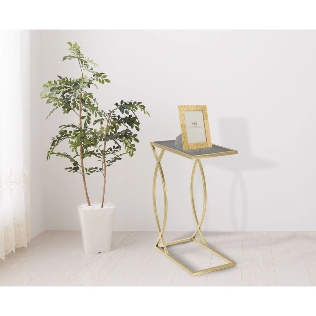 Tavolino da divano Glam in ferro oro e vetro nero 45,5x25,5x60 cm