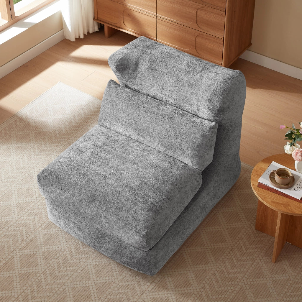 Poltrona componibile senza struttura in foam grigio, design moderno e uso versatile per soggiorno e camera da letto