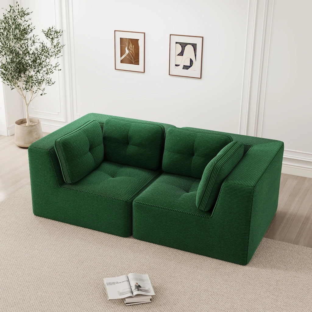 Divano angolare modulare senza struttura, rivestito in corduroy verde, con seduta profonda e comfort soffice