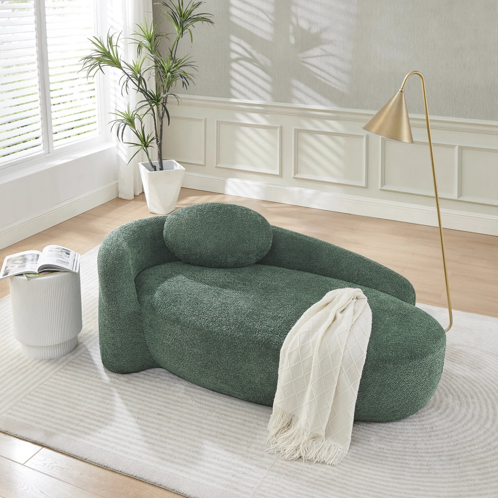 Divano compatto in Teddy verde con design arrotondato, cuscino di supporto e imbottitura elastica