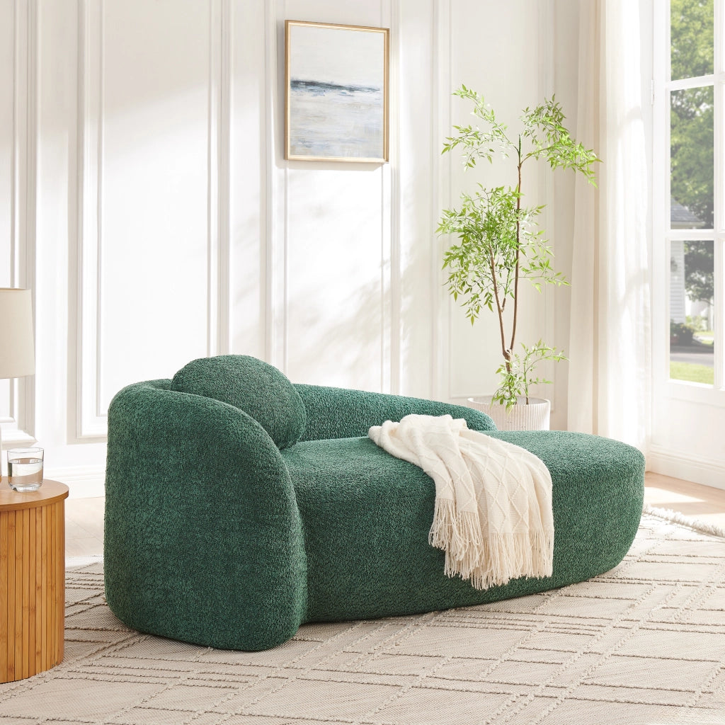 Divano compatto in Teddy verde con design arrotondato, cuscino di supporto e imbottitura elastica